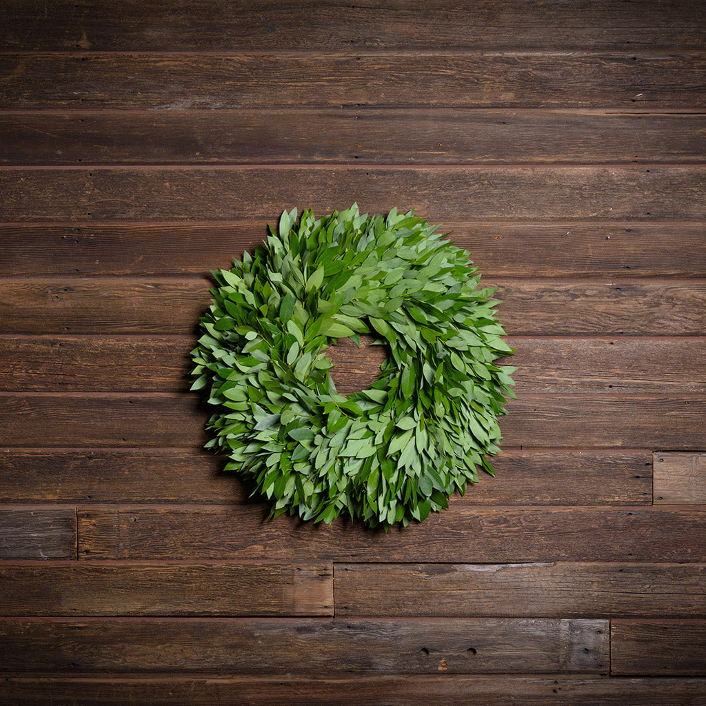 Green leaf wreath on a wooden background