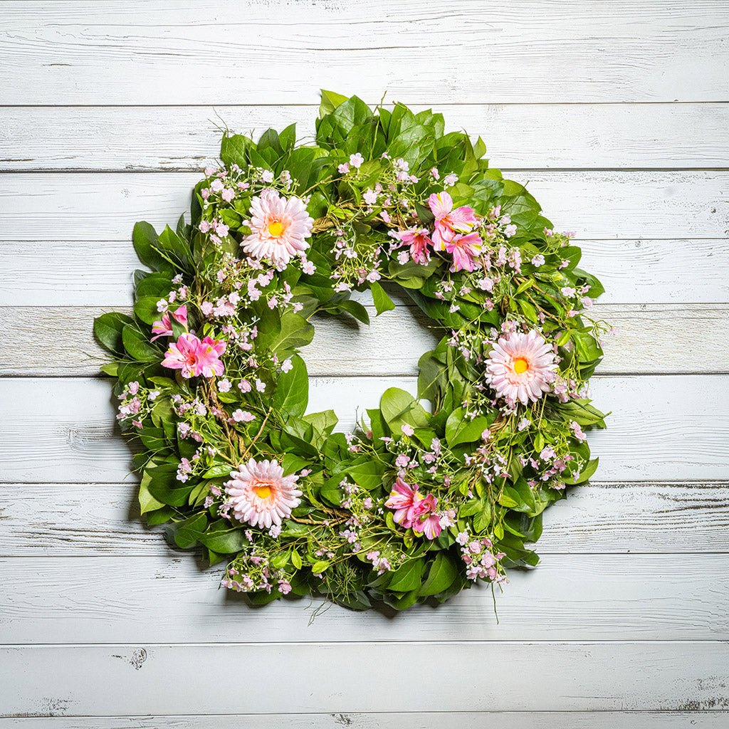 Fresh salal and sweet huckleberry with faux pink gerbera daisies, pink fairy blossoms, and pink alstroemeria flowers