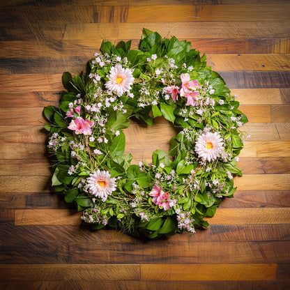 Fresh salal and sweet huckleberry with faux pink gerbera daisies, pink fairy blossoms, and pink alstroemeria flowers