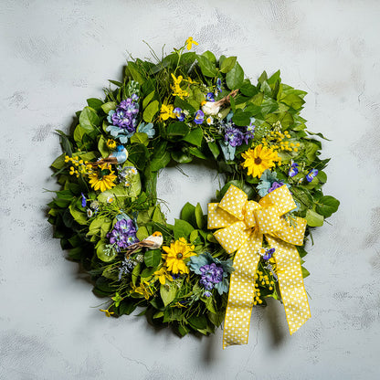 Fresh salal and sweet huckleberry with faux lavender pansies, faux yellow forsythia flowers, faux purple delphinium flowers, faux yellow daisies, and three birds with a yellow polka-dot bow