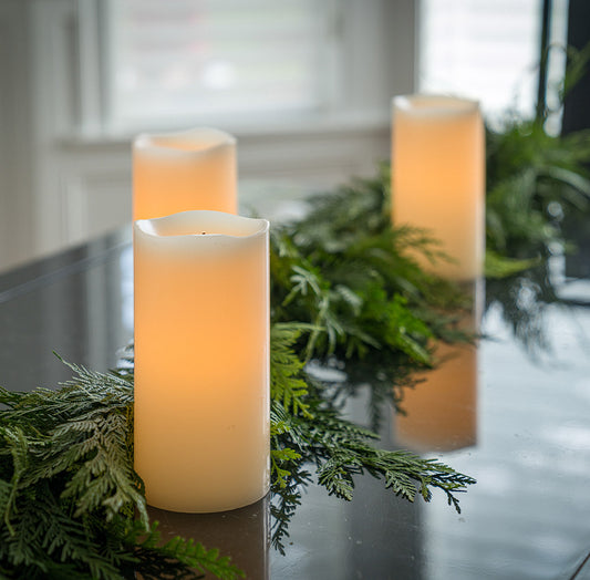 Set of 2 ivory colored LED candles and their packaging and remote