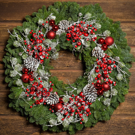 Red frosted berries and red balls on evergreen wreath