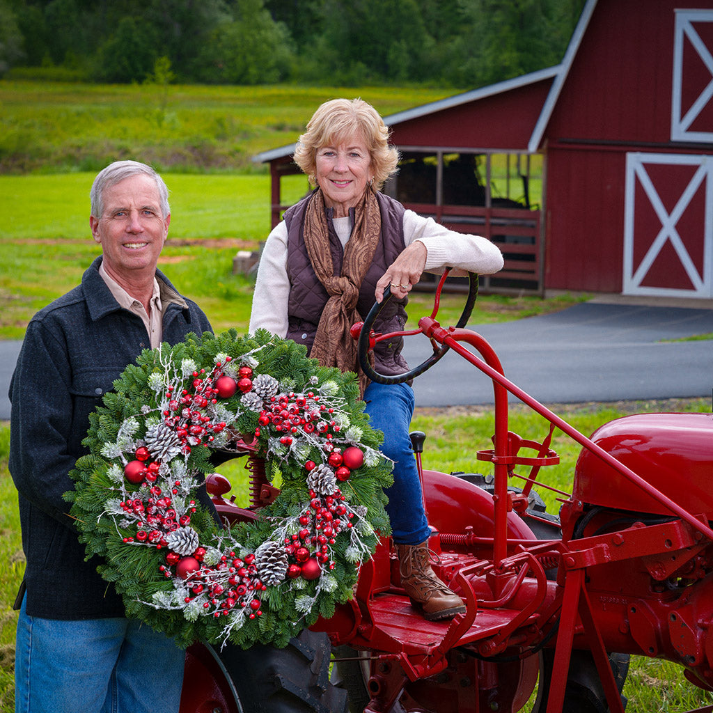 Red frosted berries and red balls on evergreen wreath