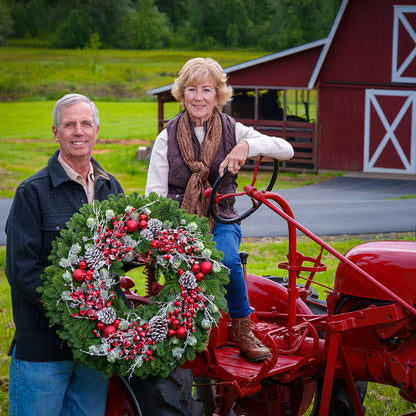 Red frosted berries and red balls on evergreen wreath