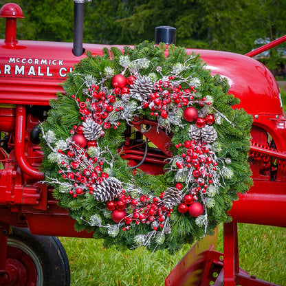 Red frosted berries and red balls on evergreen wreath