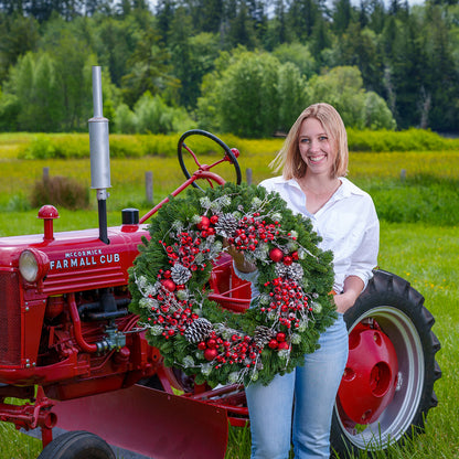 Red frosted berries and red balls on evergreen wreath