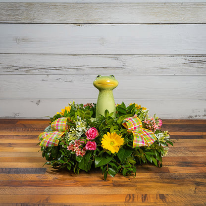 Fresh salal and green huckleberry with faux yellow daisies, faux pink wax flowers, faux mini roses, faux variegated greens, plaid bows, and a ceramic frog decoration