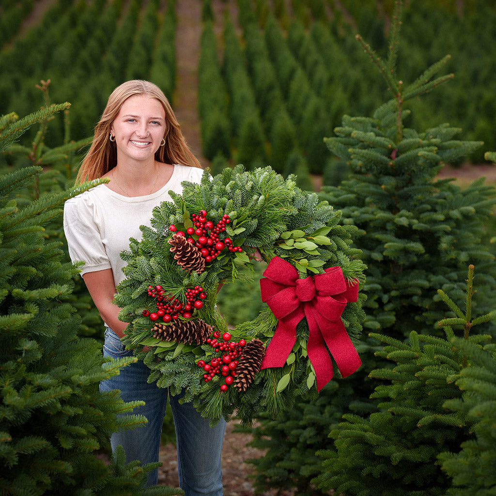 Red Berries and red linen bow on evergreen wreath