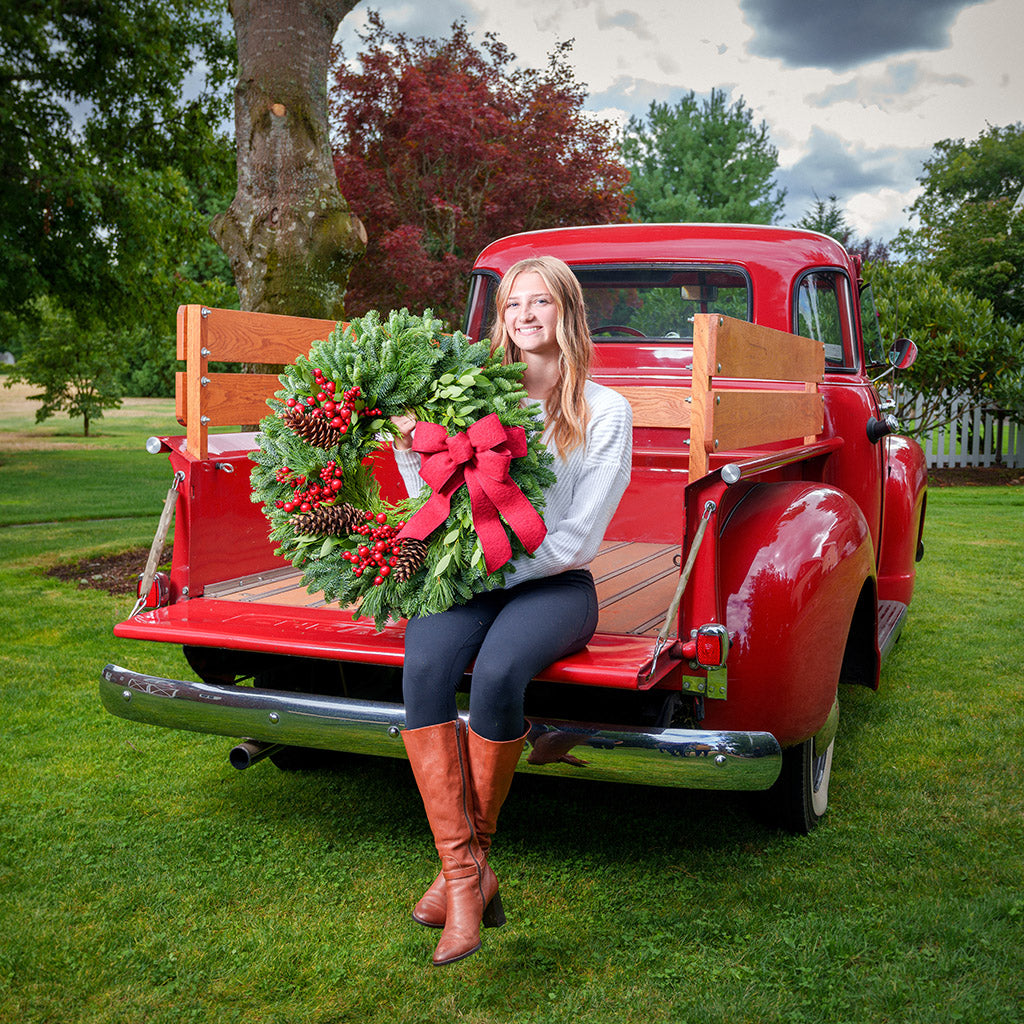 Red Berries and red linen bow on evergreen wreath