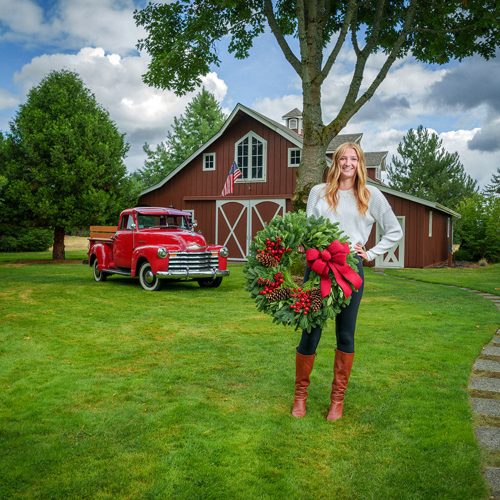 Red Berries and red linen bow on evergreen wreath