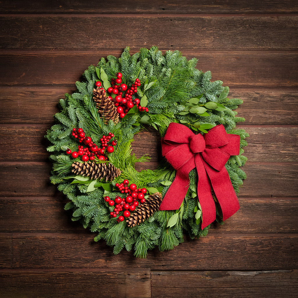 Red Berries and red linen bow on evergreen wreath