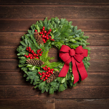 Red Berries and red linen bow on evergreen wreath