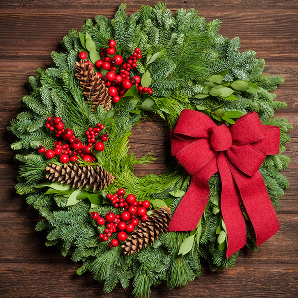 Red Berries and red linen bow on evergreen wreath