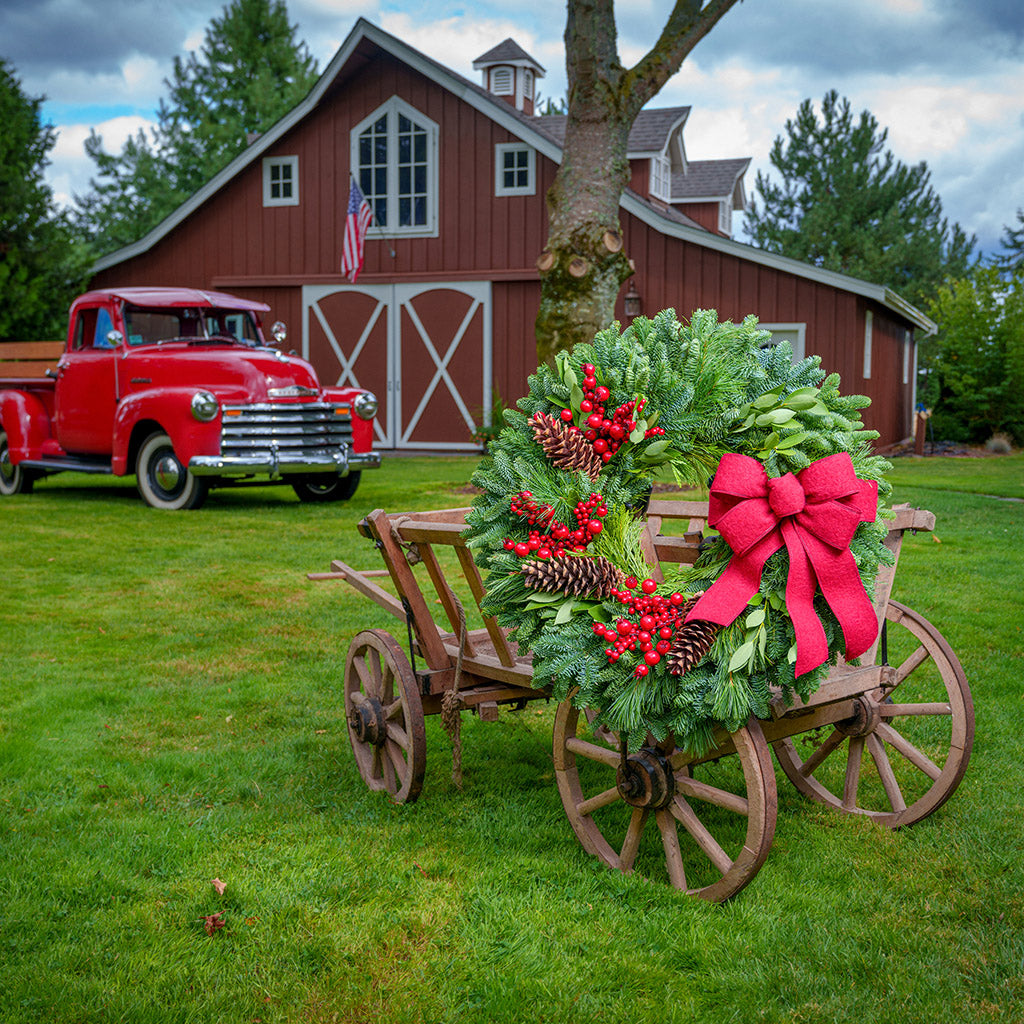 Red Berries and red linen bow on evergreen wreath