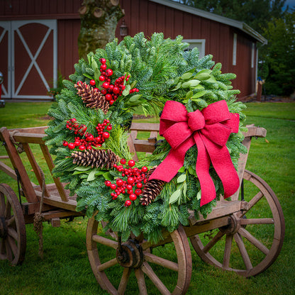 Red Berries and red linen bow on evergreen wreath