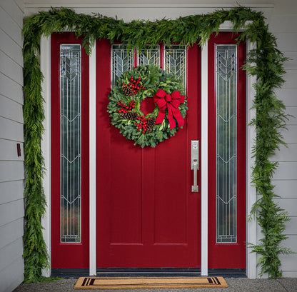 Red Berries and red linen bow on evergreen wreath