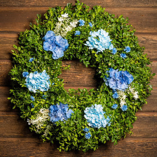 Fresh boxwood with faux blue hydrangeas and blue statice flowers