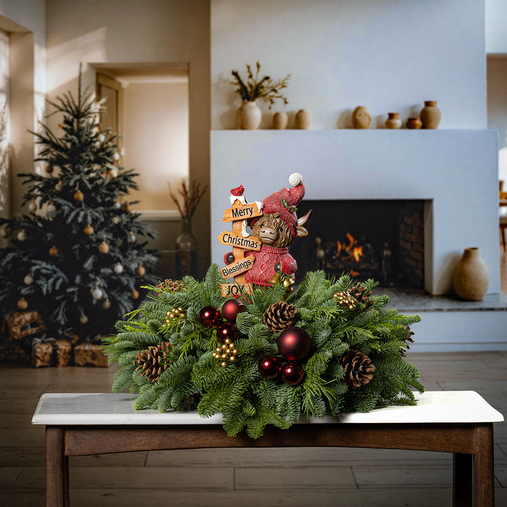 Christmas wreath with decorative figure on a table in a cozy living room.