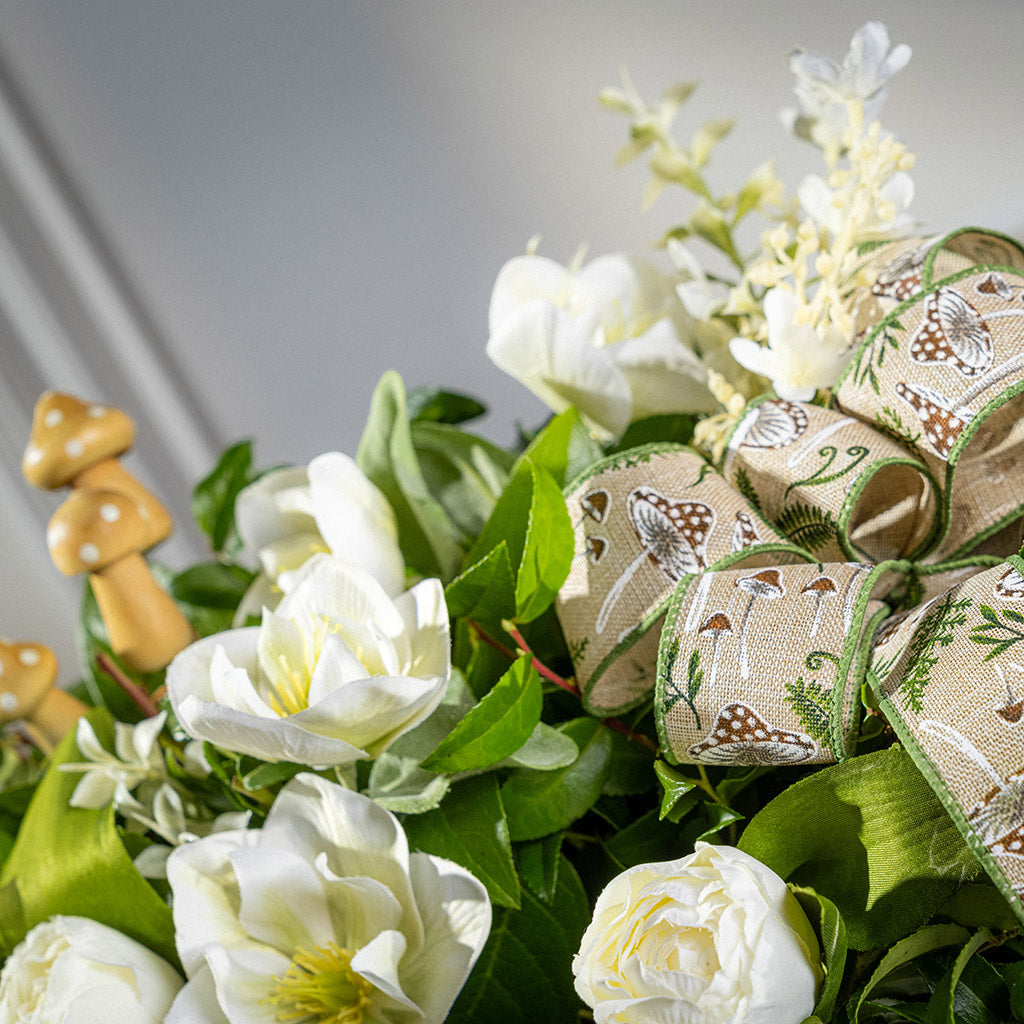 Fresh salal and green huckleberry with faux white tulips, faux white small flowers, faux white hellebores flowers, faux wood mushrooms, and a fern & mushroom bow in a wildflower-themed wooden box