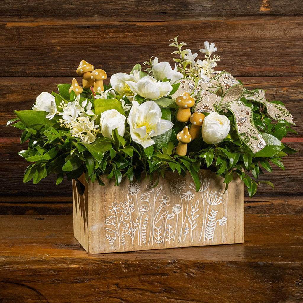 Fresh salal and green huckleberry with faux white tulips, faux white small flowers, faux white hellebores flowers, faux wood mushrooms, and a fern & mushroom bow in a wildflower-themed wooden box