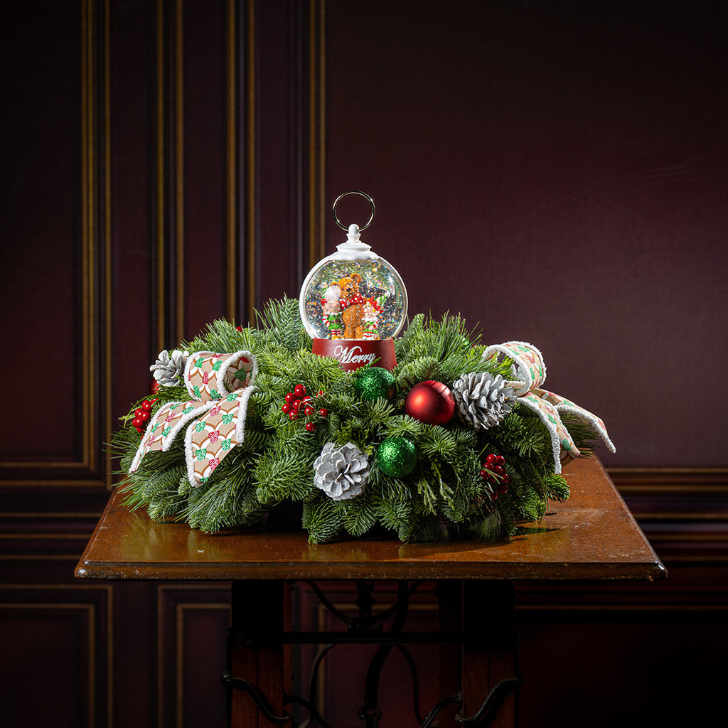 noble fir, cedar, and pine with green-and-red glittery ball ornaments, frosted pinecones, faux red berries, pink-and-green gumdrop-themed bow tucks, and a red holiday-themed water globe