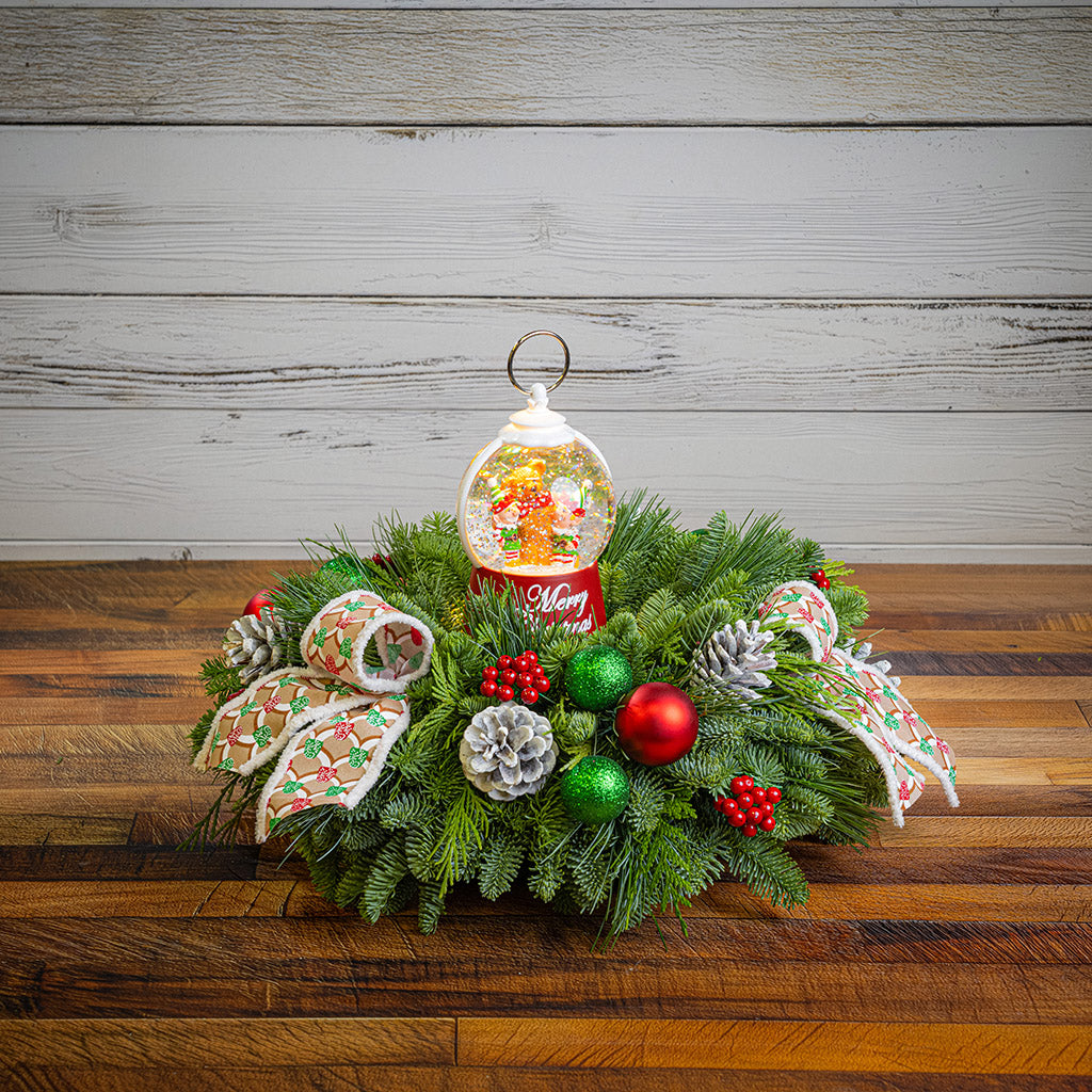 noble fir, cedar, and pine with green-and-red glittery ball ornaments, frosted pinecones, faux red berries, pink-and-green gumdrop-themed bow tucks, and a red holiday-themed water globe