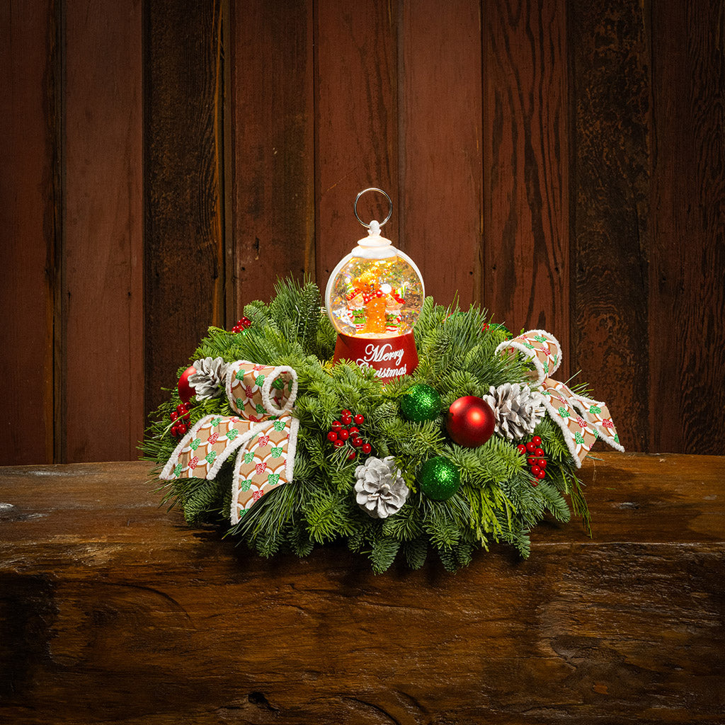 noble fir, cedar, and pine with green-and-red glittery ball ornaments, frosted pinecones, faux red berries, pink-and-green gumdrop-themed bow tucks, and a red holiday-themed water globe