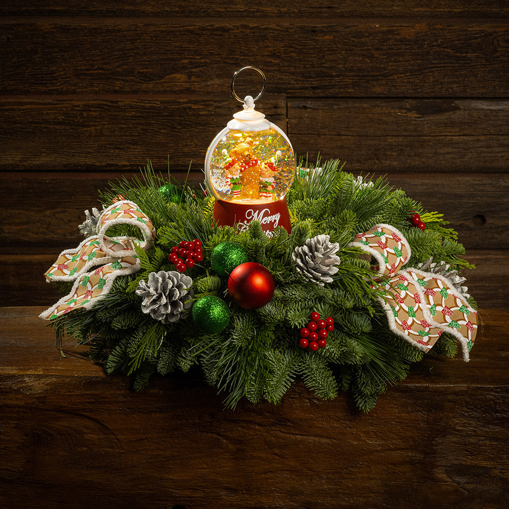 noble fir, cedar, and pine with green-and-red glittery ball ornaments, frosted pinecones, faux red berries, pink-and-green gumdrop-themed bow tucks, and a red holiday-themed water globe