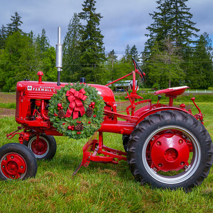 Red balls and berries with a red sparkle bow on evergreen wreath