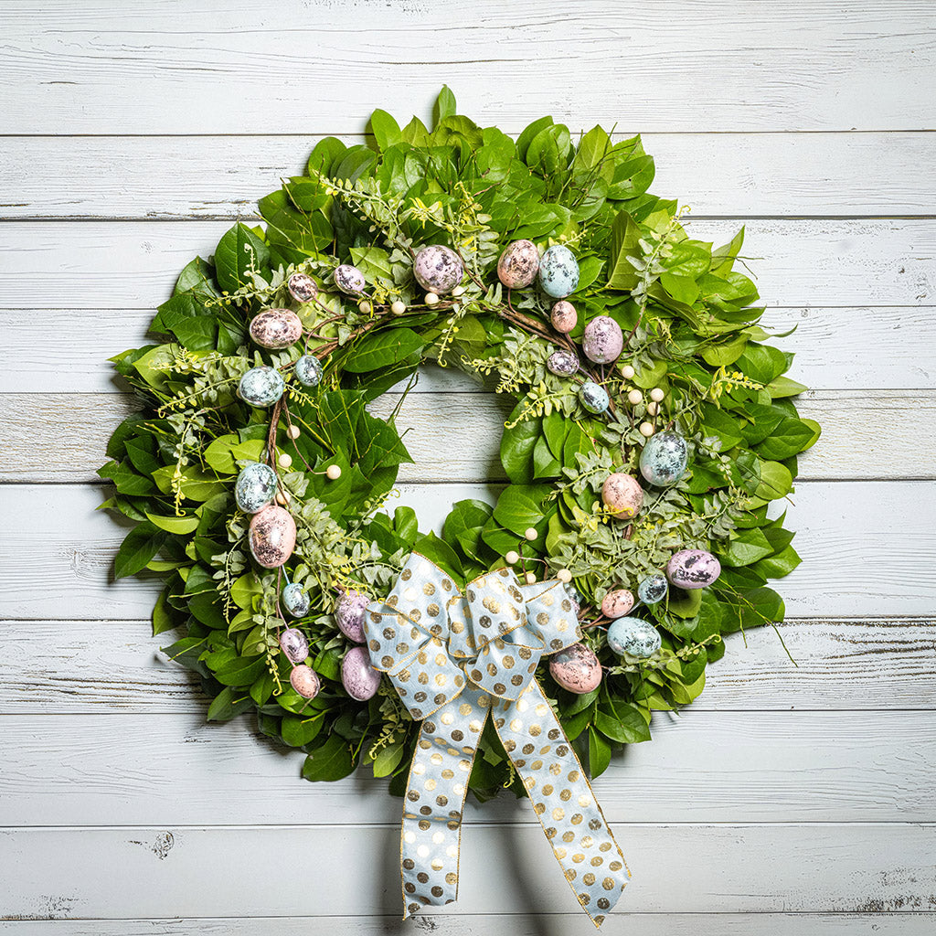 Fresh salal and sweet huckleberry with metallic pastel eggs and faux fern leaves with a light-blue polka dot bow