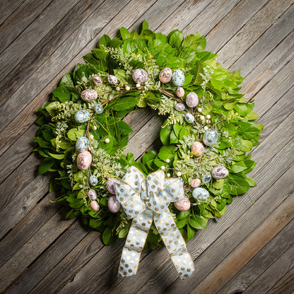 Fresh salal and sweet huckleberry with metallic pastel eggs and faux fern leaves with a light-blue polka dot bow