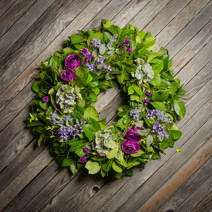 Fresh salal and sweet huckleberry with faux purple ranunculus flowers, purple statice, faux purple hydrangeas, and faux light-purple berries