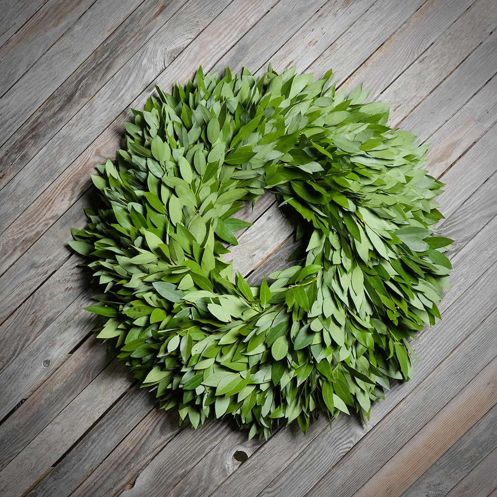 Green leaf wreath on a wooden surface