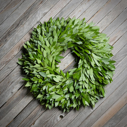 Green leaf wreath on a wooden surface