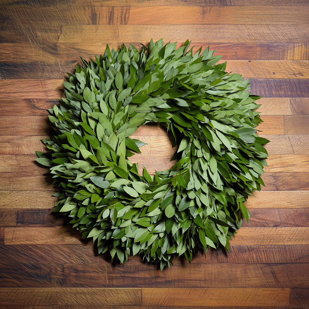 Green leaf wreath on a wooden surface