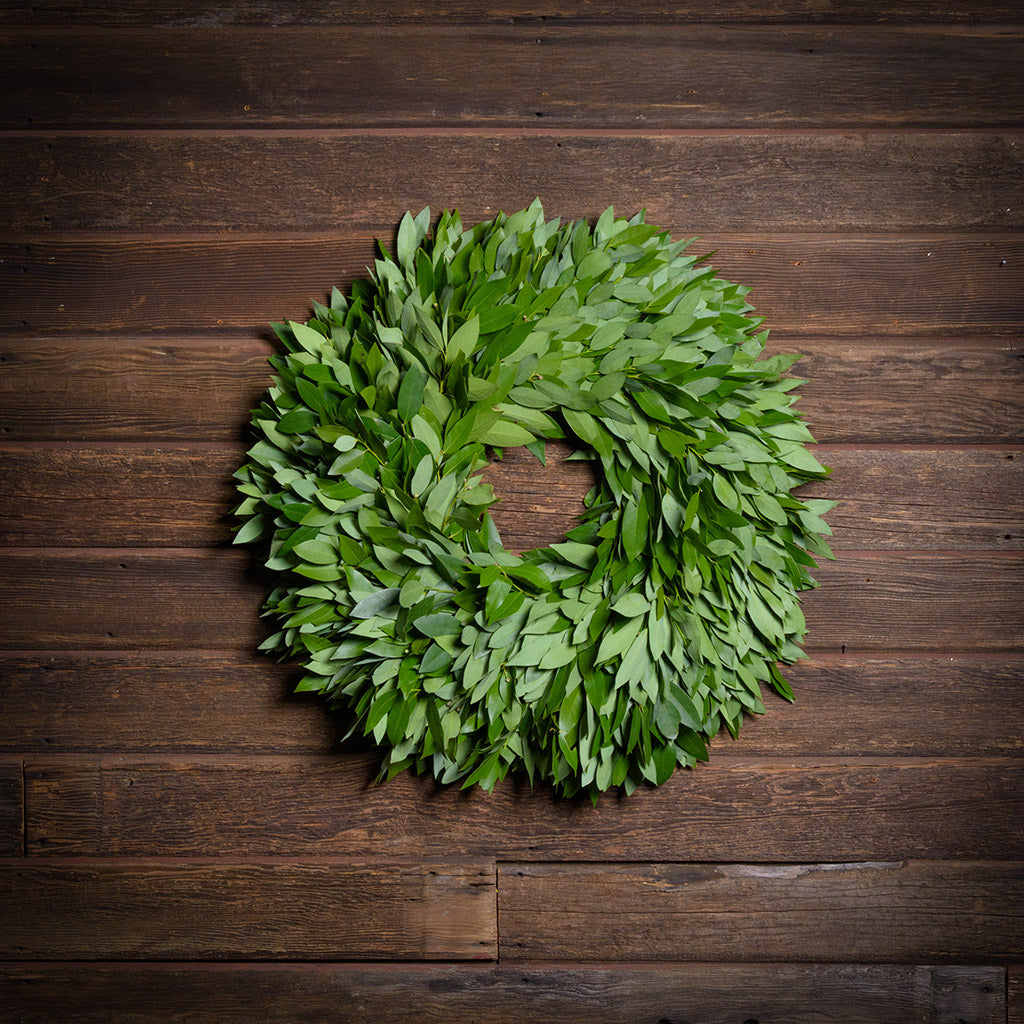 Green leaf wreath on a wooden background
