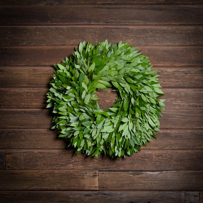 Green leaf wreath on a wooden background