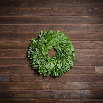 Green leaf wreath on a wooden background