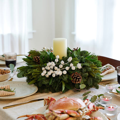 Centerpiece made of noble fir, pine, cedar and bay leaf with white berry clusters, Australian pine cones and 1 white LED pillar candle