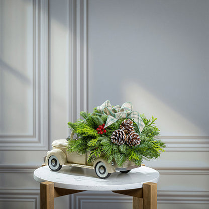 noble fir, cedar, and pine with faux red berries, frosted pinecones, and a sage plaid bow in a cream metal truck container