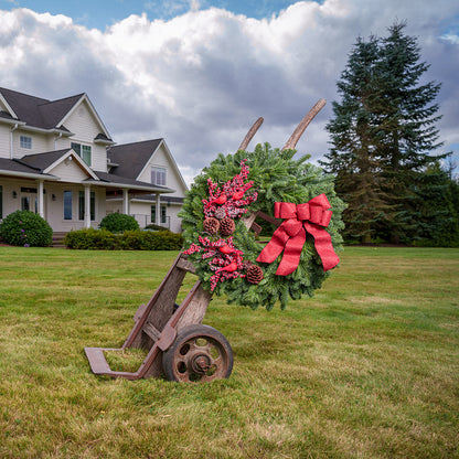 red cardinals with red berries and red sparkle bow on evergreen wreath