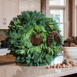 Christmas wreath with bay leaves, pine cones with no bow close up on a kitchen counter