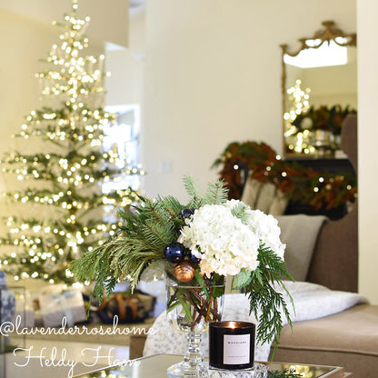 Close up loosely arranged Noble Fir in 6"-24” length pieces, Incense Cedar in 6" - 18" length pieces, and Juniper in 6" - 12" length pieces used in an arrangement.