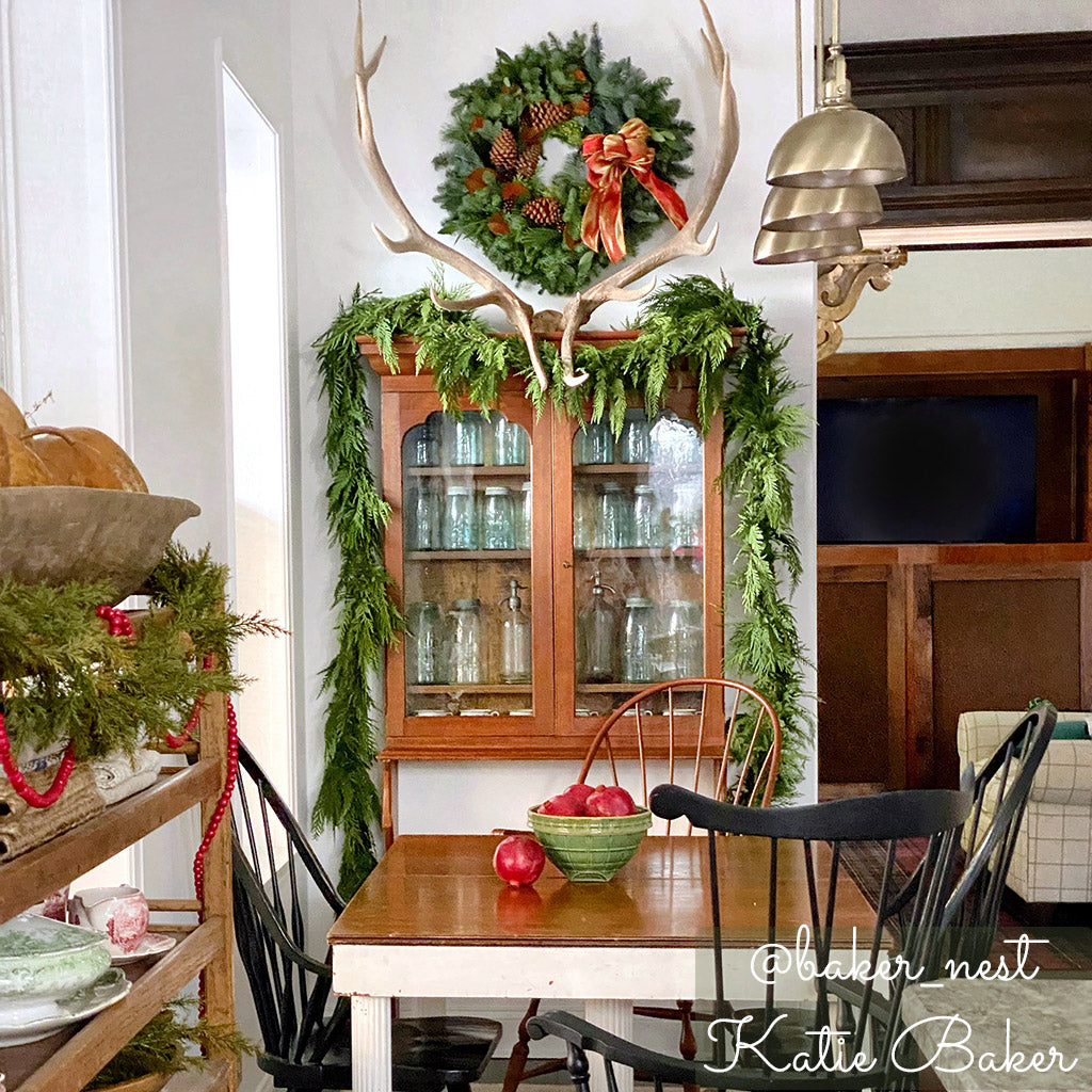 Western red cedar garland hung on a cabinet in a dining room.