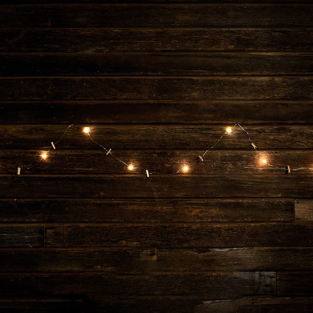 10-foot strand of white lights and mini wood clothespins with a dark wooden background.