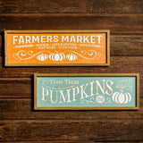 Set of 2 fall signs for Farmers Market and Pumpkins hung on a wooden background.
