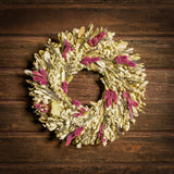 18" wreath with a blend of dried integrifolia, white larkspur, English lavender, pink phalaris, and white statice on a dark brown background.