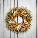 22" wreath made of corn husk, phalaris, natural flax, maple leaves, and dried quince slices on a white wood fence background. 