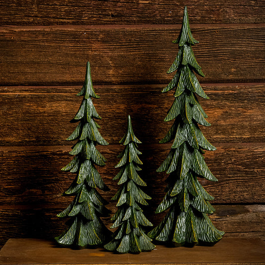 Set of 3 green resin evergreen trees with a dark wooden background.