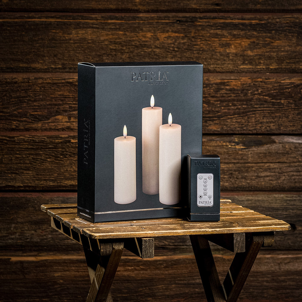 Set of 3 ivory LED candles with a 360 degree flame in their original packaging.